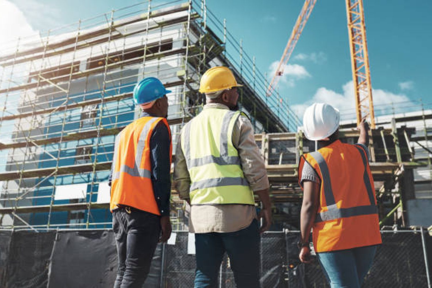 Shot of a group of builders assessing progress at a construction site construction